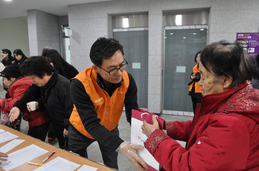 설 배식을 위하여 어르신손을 잡고 안내하는 직원